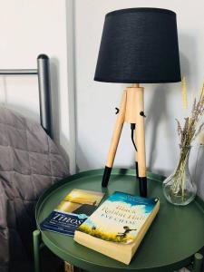 a lamp sitting on a table with a book and a lamp at Elena Studios in Panormos