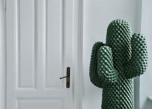 a cactus is standing next to a door at Apartment Trdinova in Ljubljana