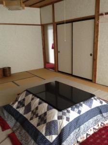 a room with a glass table on the floor at Miyasakaya in Nozawa Onsen