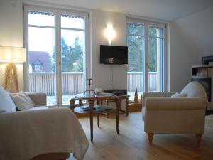 a living room with a couch and a table at Ferienwohnung Passivhaus "Schöne Aussicht" in Georgensgmünd