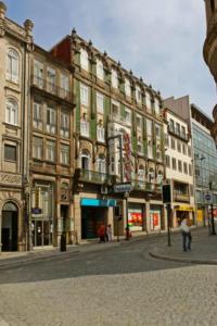 a city street with tall buildings in a city at Hotel Peninsular- Porto in Porto