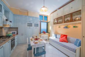 a kitchen and living room with a couch and a table at Monastero Santa Rosalia in Atrani