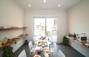 卡利亞里的住宿－Centro storico via Sassari Accommodation，一间带桌椅和窗户的用餐室