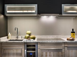 a kitchen with a sink and some fruit on the counter at MGM Hôtels & Résidences - Résidence Chalets Elena in Les Houches