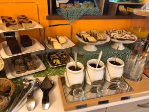 a buffet of desserts and pastries on a counter at Garni Villa Betty in Merano