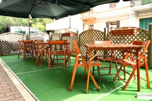 a group of tables and chairs under an umbrella at Hotel Belvedere in Viareggio