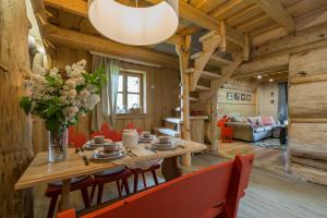 a dining room with a wooden table and chairs at Domek Szałas pod Dębem in Ząb