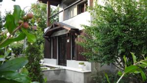 a house with black and white windows and trees at Vila Hera in Eforie Sud