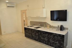 a kitchen with a sink and a tv on the wall at 2 Bedrooom In CENTER Всегда есть свет ! in Odesa