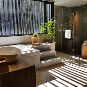 a bathroom with a sink and a shower with plants at Shaoguang 188 in Yuchi