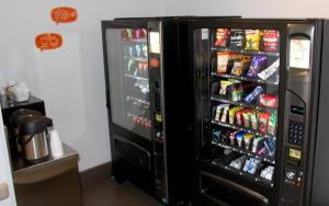 a refrigerator filled with lots of sodas and drinks at Hotel Hi! Santa Catarina in Monterrey