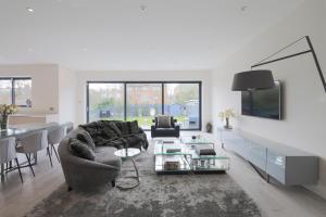 a living room with a couch and a table at House for Wimbledon Tennis in Raynes Park