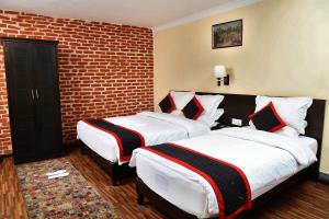 Postel nebo postele na pokoji v ubytování Taleju Boutique Hotel