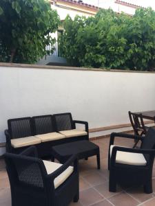 a patio with two chairs and a table and chairs at Apartamentos Llafranc Mar in Llafranc