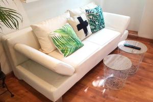 a white couch with pillows on it in a living room at GregBnb - T2 Cosy et design - PARKING INCLUS - WiFi - 15min Gare in Toulon +15 photos