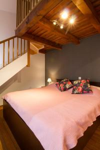 a bedroom with a bed with two pillows and a staircase at Apartment Atlantis in Pula