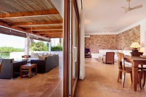 a dining room and living room with a table at Can Mares in Cala Tarida
