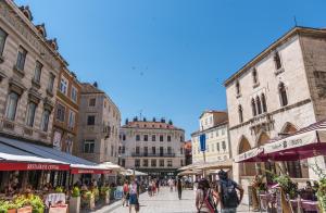 a group of people walking down a city street at Cvit Jadrana in Split
