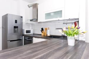 a kitchen with a counter top with a vase of flowers at Cvit Jadrana in Split