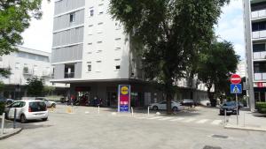 a parking lot with cars parked in front of a building at Cvit Jadrana in Split