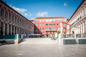 a group of buildings with people walking down the stairs at Cvit Jadrana in Split