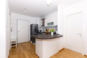 a kitchen with white walls and a black counter top at Cvit Jadrana in Split