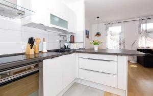 a kitchen with white cabinets and a counter top at Cvit Jadrana in Split