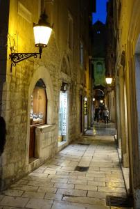 an alley in an old town at night at Cvit Jadrana in Split