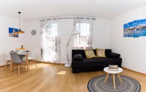 a living room with a black couch and a table at Cvit Jadrana in Split