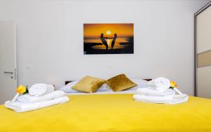 a bedroom with a bed with towels on it at Cvit Jadrana in Split