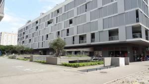 a large gray building with benches in front of it at Cvit Jadrana in Split