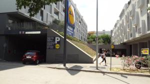 a person walking down a street next to a parking garage at Cvit Jadrana in Split