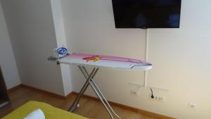 a table in a room with a tv on a wall at Cvit Jadrana in Split