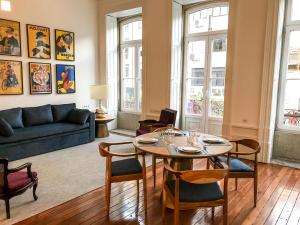 a living room with a table and chairs and a couch at Downtown Colosseum Apartments in Porto