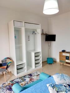 a bedroom with a large white cabinet and a bed at Piana delle Galee in Scilla