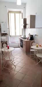 a kitchen with a table and chairs and a kitchen with a stove at Myomax Guesthouse in Rome