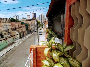 a balcony with plants on the side of a building at Léa Pousada in Fortaleza
