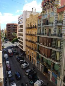a city street with cars parked in front of buildings at KM0 CENTRO CIUDAD in Valencia