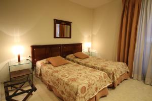 En eller flere senge i et værelse på Apartaments St. Jordi Comtal