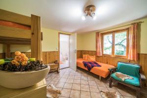 a bedroom with a bed and a room with a bowl of fruit at Chata Kytlice in Kytlice