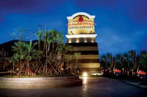 a hotel sign with palm trees in front of it at Maleewana Hotel & Resort in Ban Bang Muang