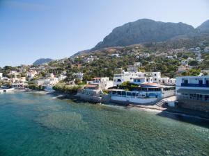 an aerial view of a town next to the water at Avra Studios in Myrties