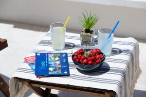 a table with a bowl of fruit and two glasses of milk at The Little Prince in Lopud
