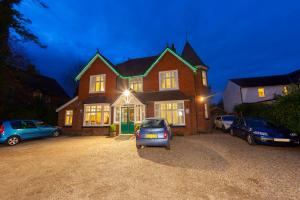 a house with a car parked in front of it at Gatwick Turret Guest House in Horley