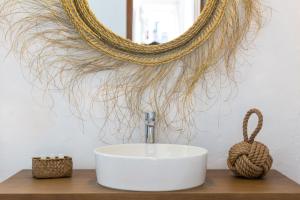 a bathroom with a sink and a mirror at Hostal La Torre Ibiza Cap Negret in San Antonio