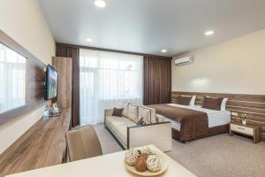 a hotel room with a bed and a couch at Imperial Sun in Anapa