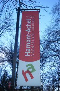 a banner hanging from a street light pole at Hotel Hooghuys in Hamont