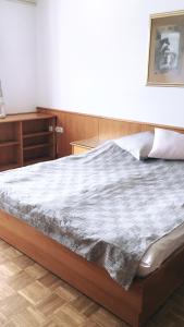 a bedroom with a large bed with a wooden headboard at Gostisce Sobocan in Maribor
