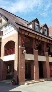 a brick building with an archway in front of it at Evergreen Residence VárLak in Debrecen +12 photos