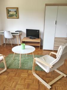 a living room with a table and a chair at Gostisce Sobocan in Maribor